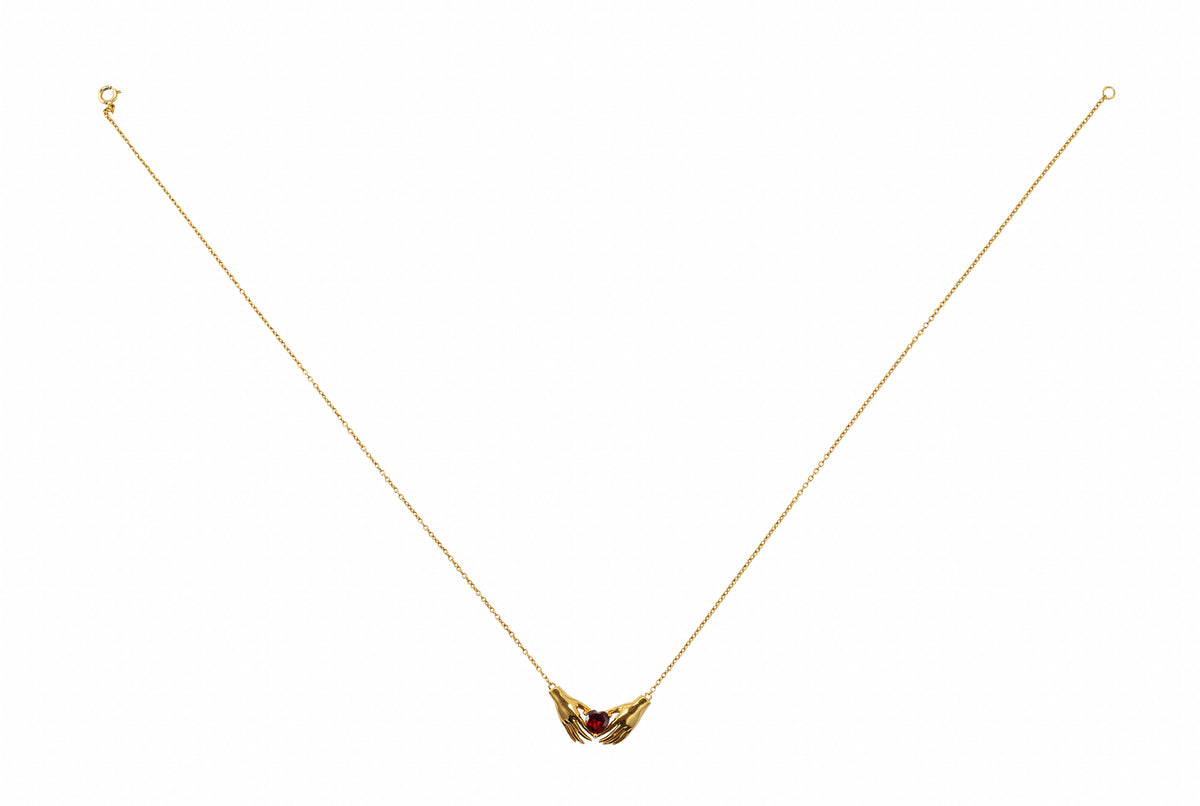 Heart in hand pendant